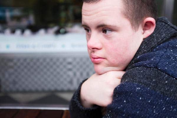 Contemplative Teenage Boy with Down Syndrome